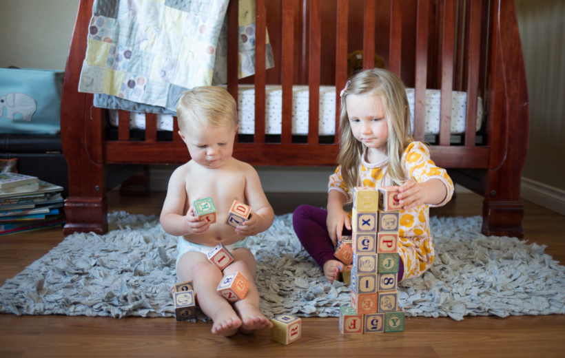 brother and sister playing with blocks